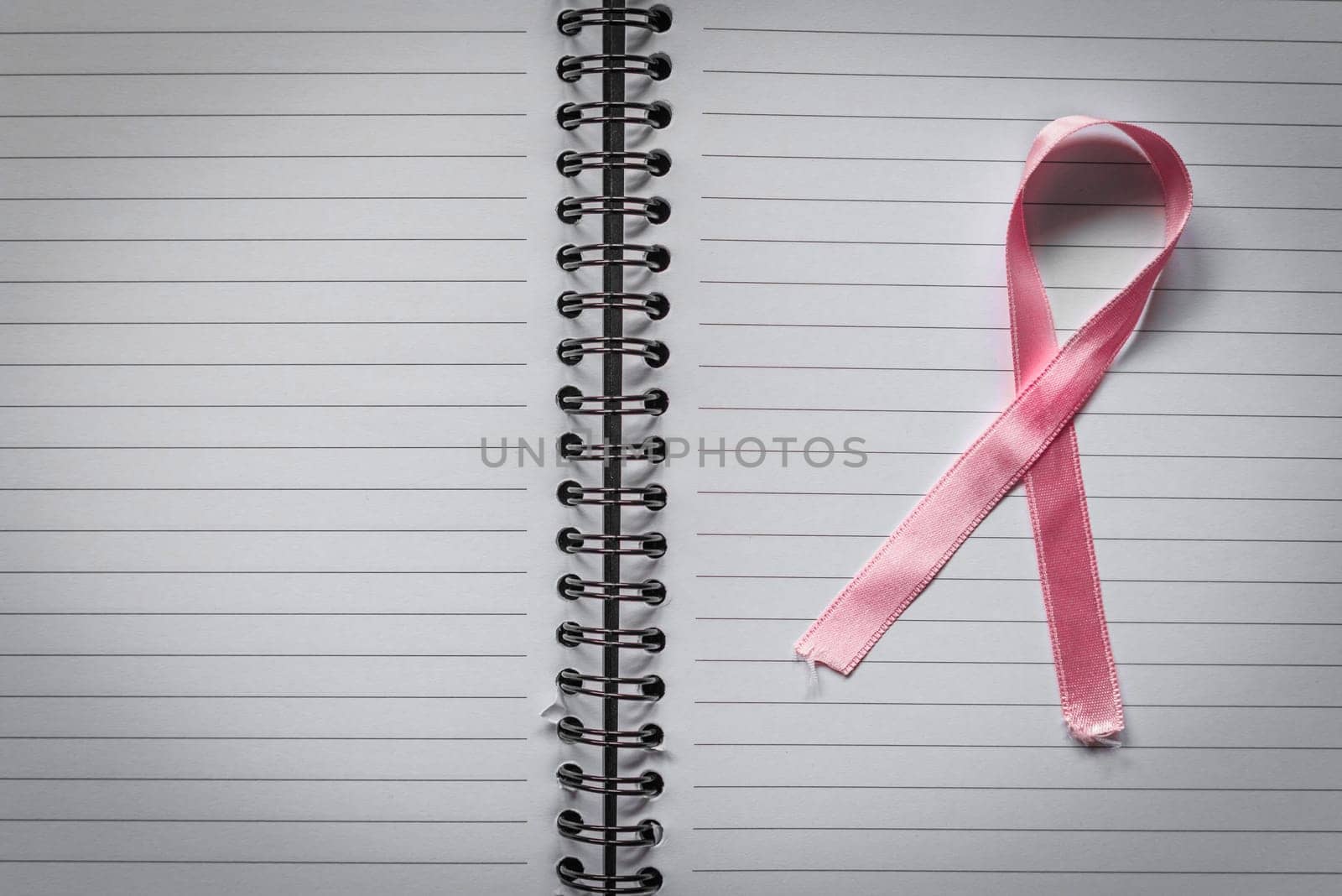 Breast cancer symbol in pink on a noteblok