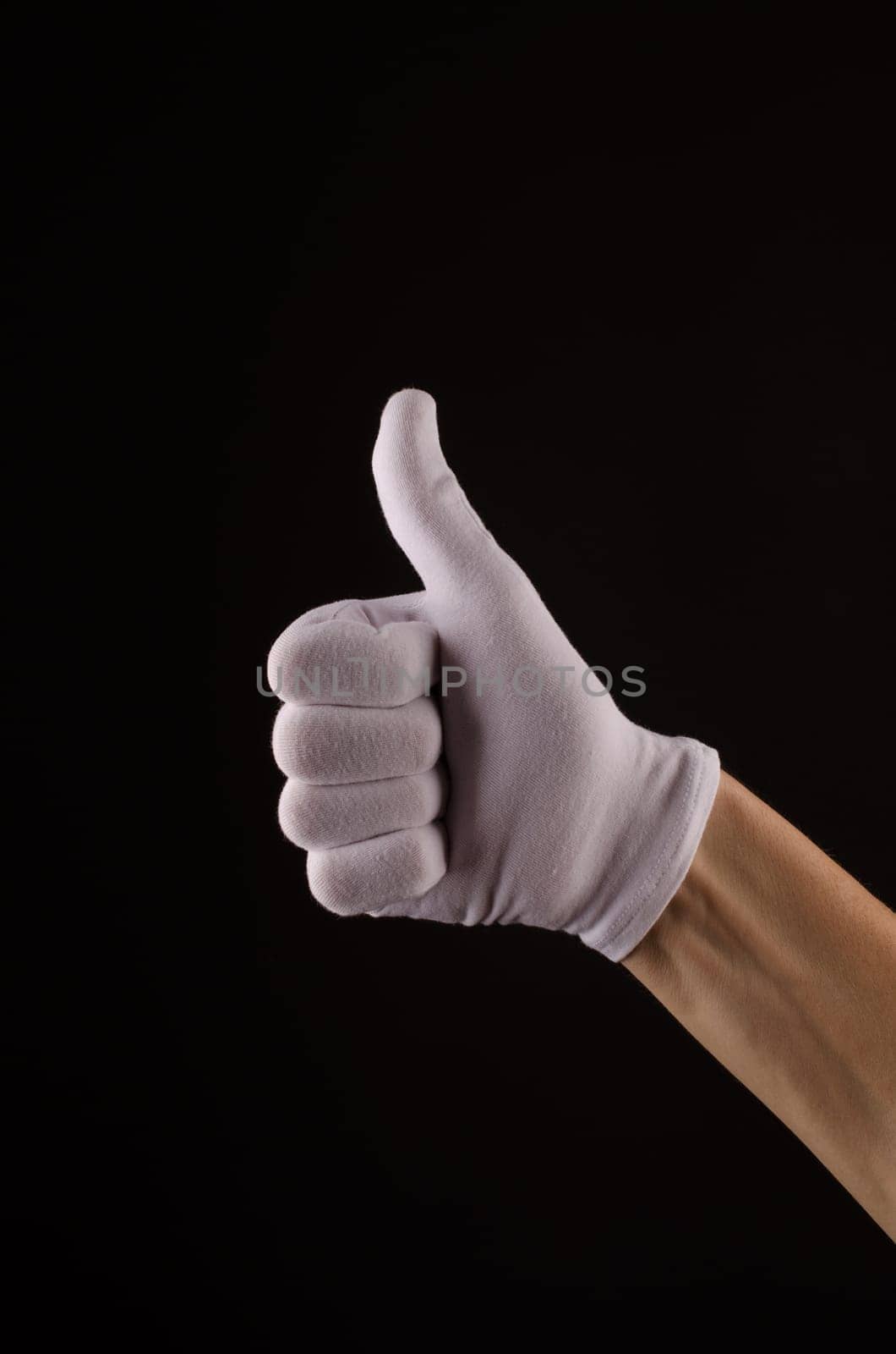 Male hand with white glove with thumb up