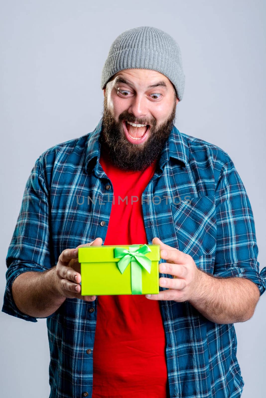 young bearded man with green gift box