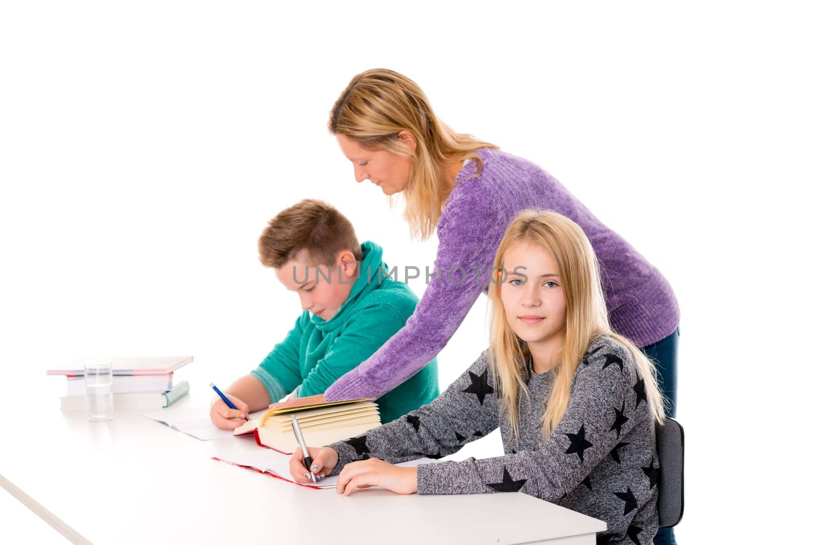 girl and boy learning together with teacher in the classroom