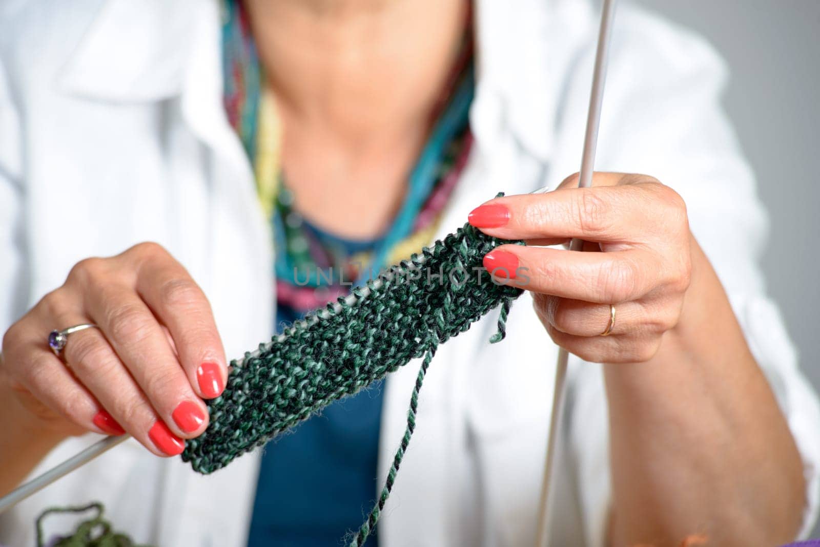 close up of the hands of a woman who knits