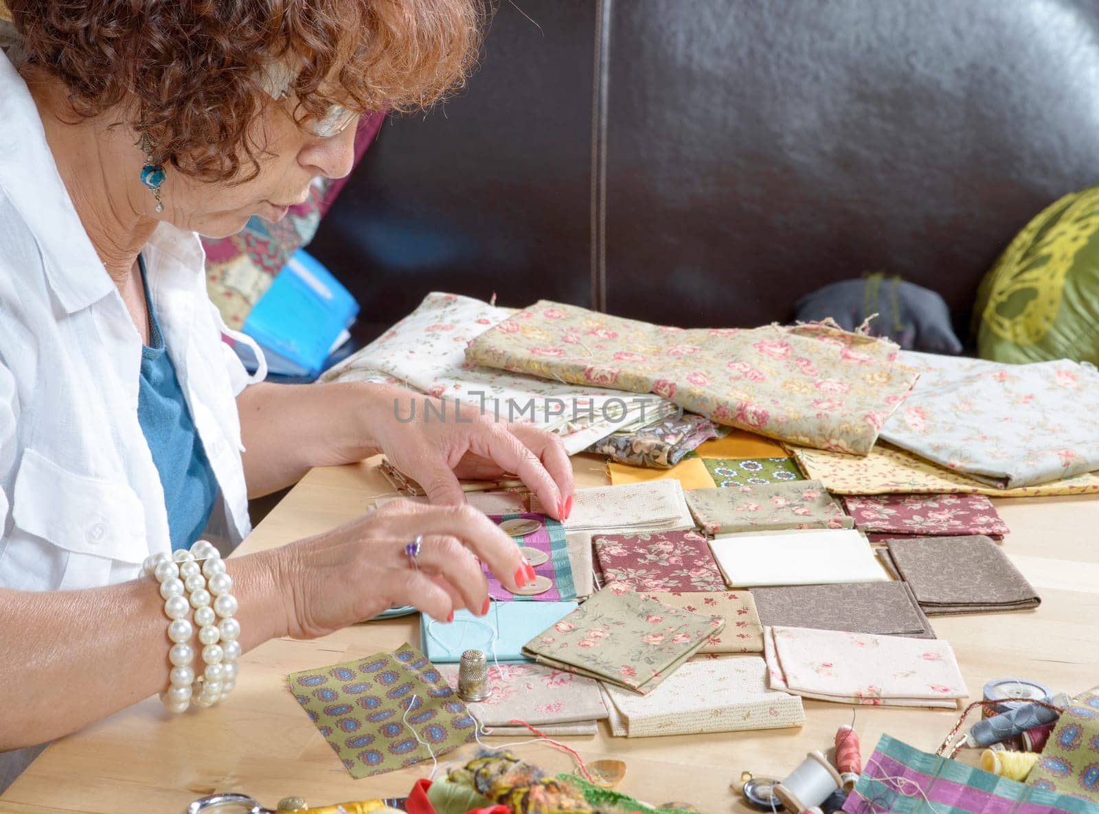 a middle-age woman sewing a patchwork