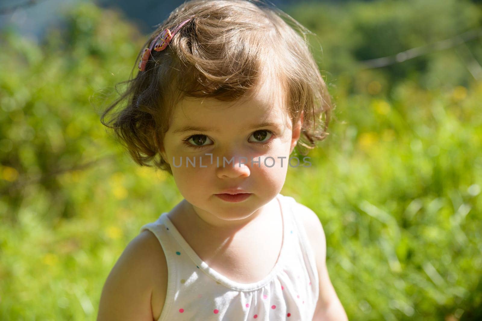 a pretty little girl looks at the camera and smiles