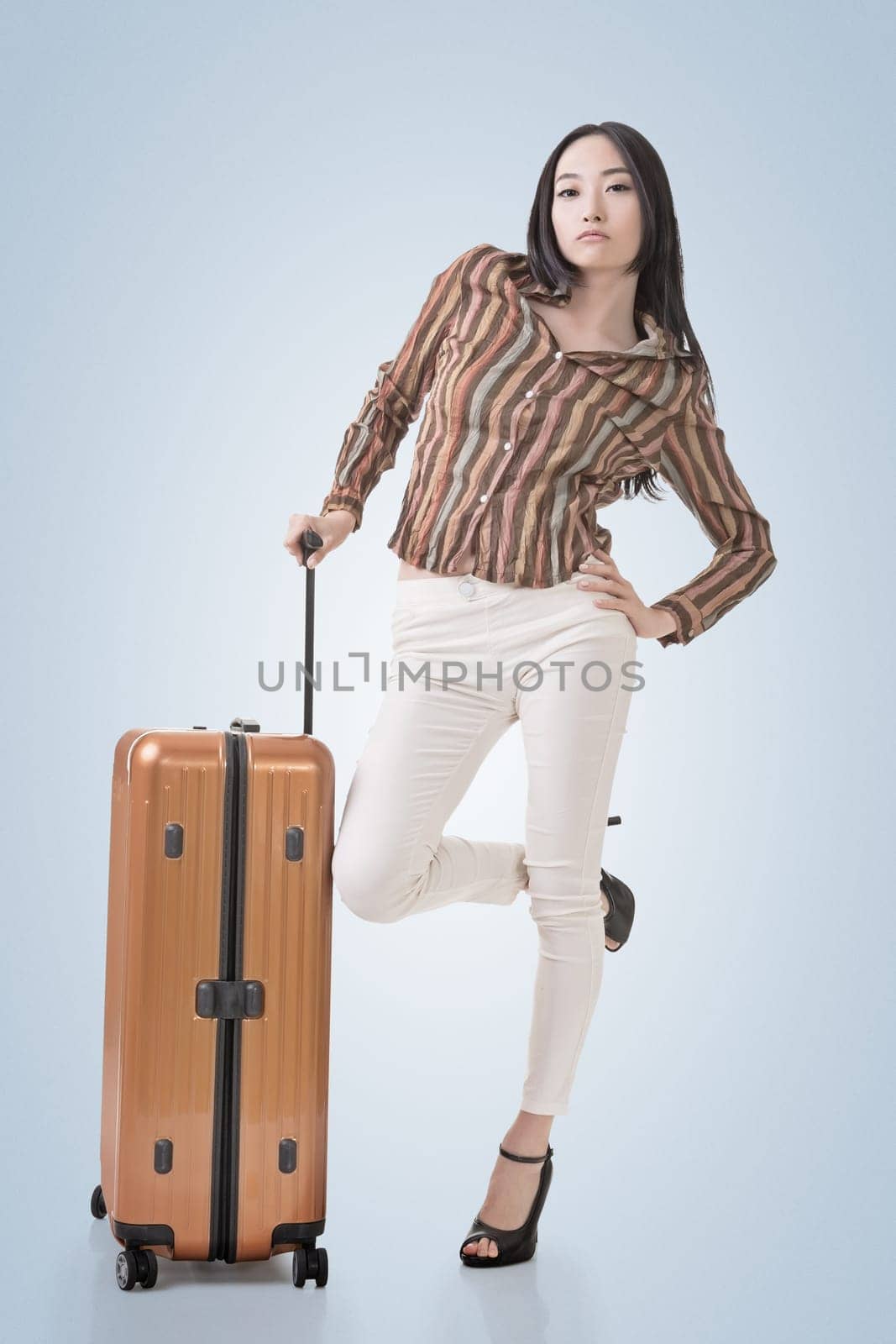 Modern Asian woman stand with a luggage in vintage style.