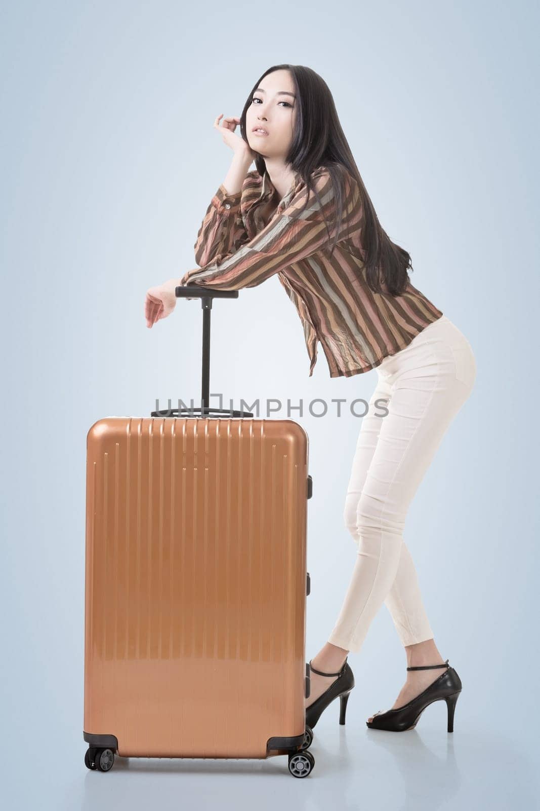 Modern Asian woman stand with a luggage.