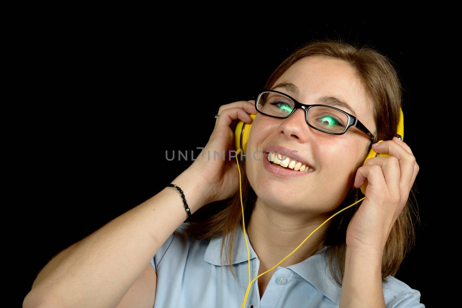 young woman listens to music with headphones