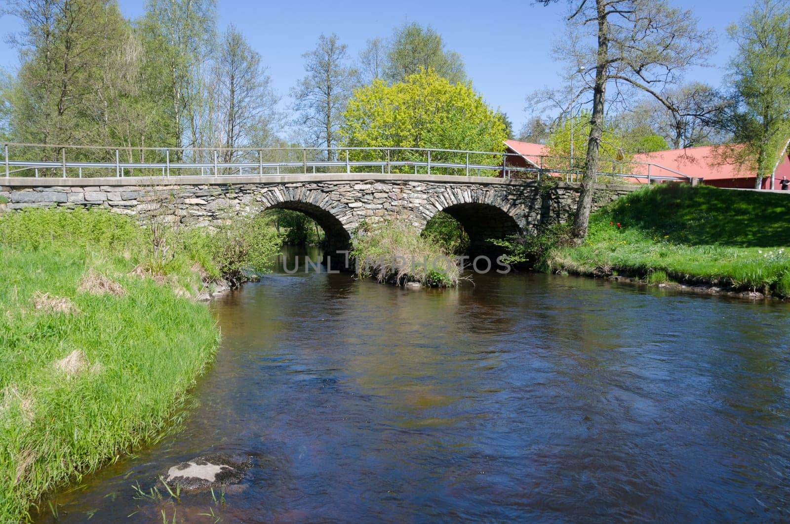 the dark water is running under the old bridge made of stone