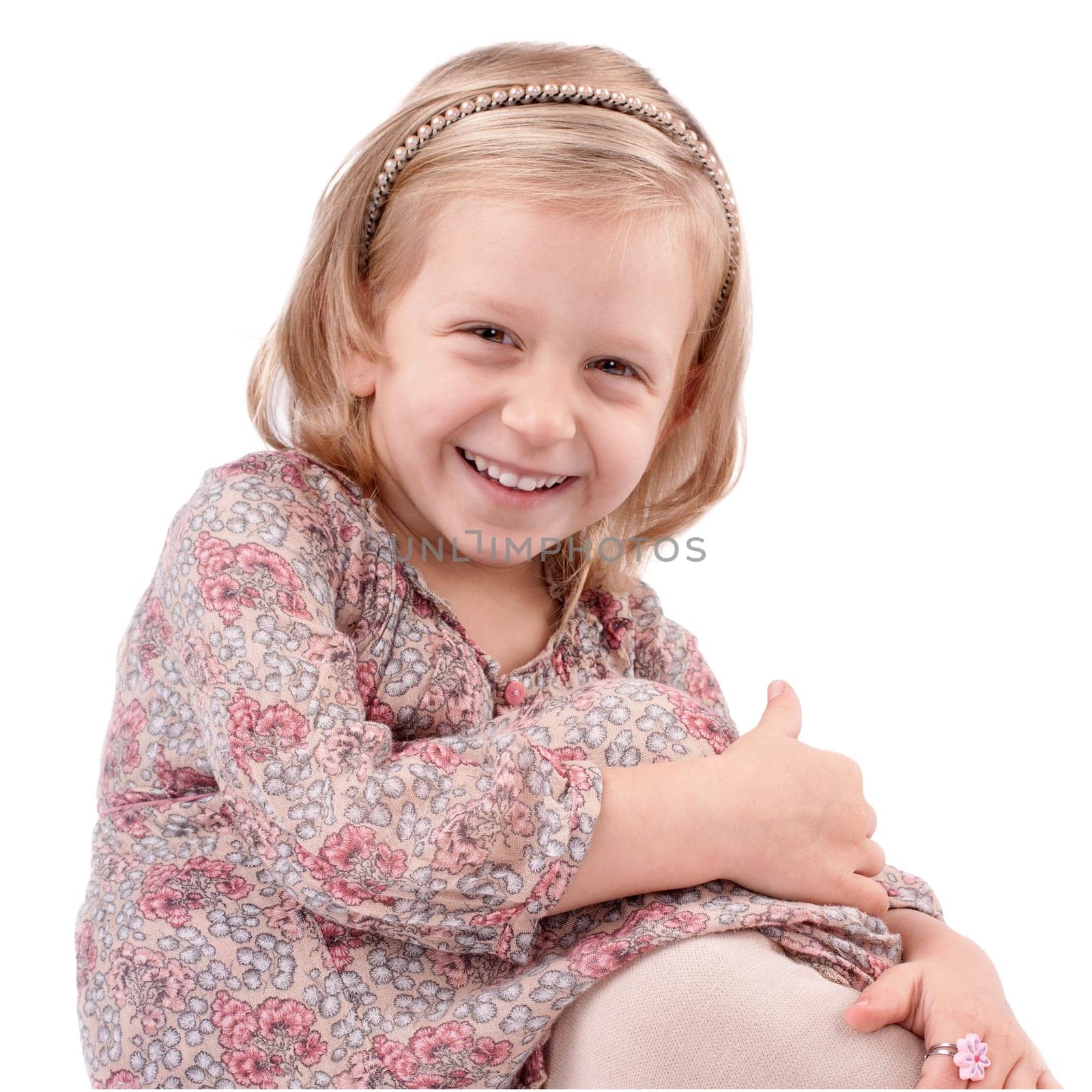 Cute little girl dressed in floral, dress having fun