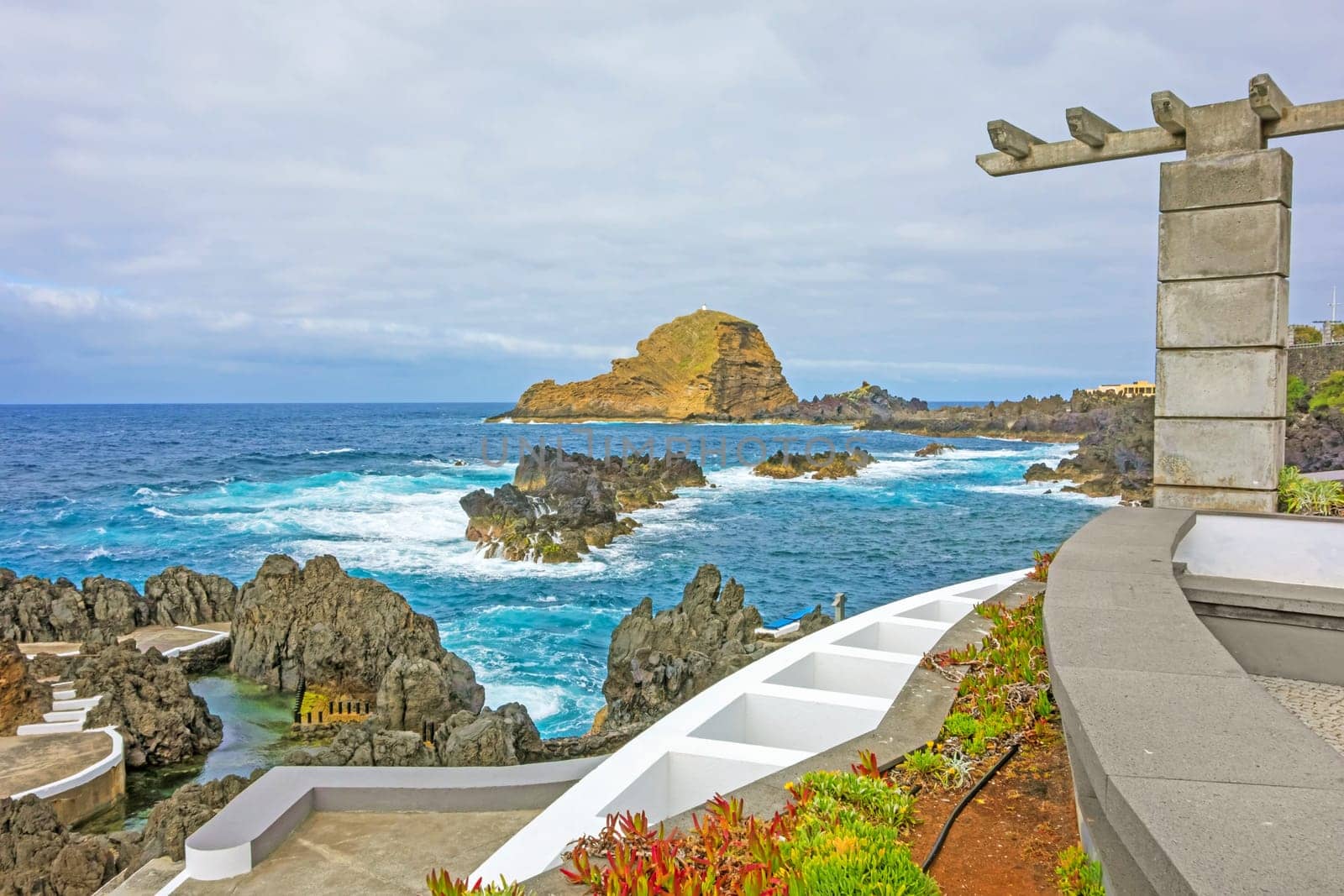 View from the natural lava rock pool in the village Porto Moniz to rock Ilheu Mole, Madeira, Portugal