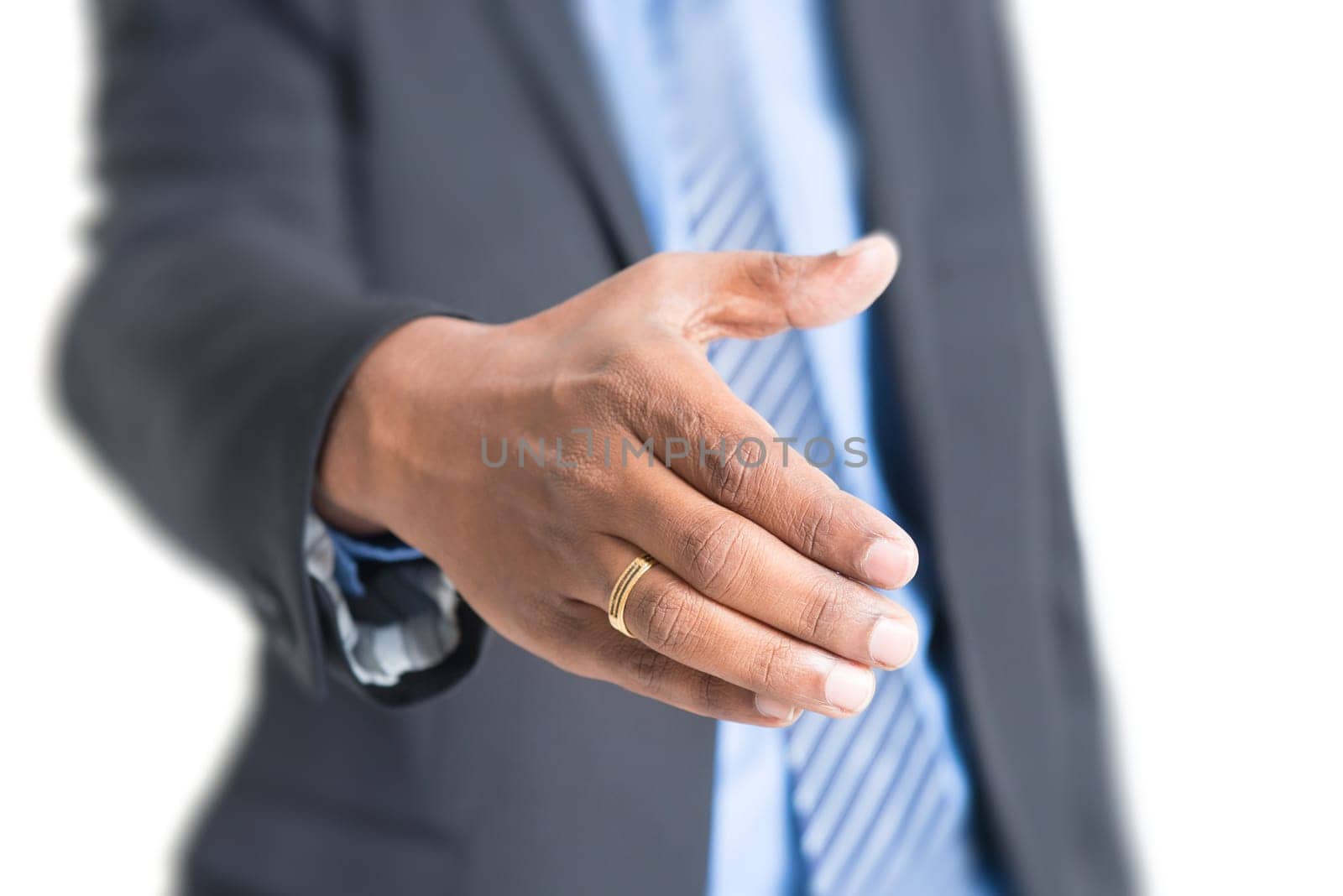 Close up Indian businessman hand offering handshake, standing on plain background.