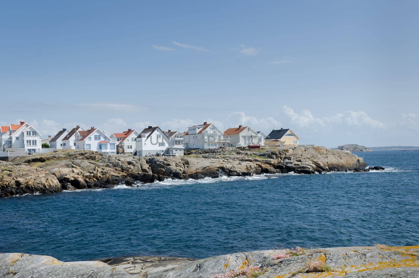 a little island on the swedish westcoast blue sky and it is blowing