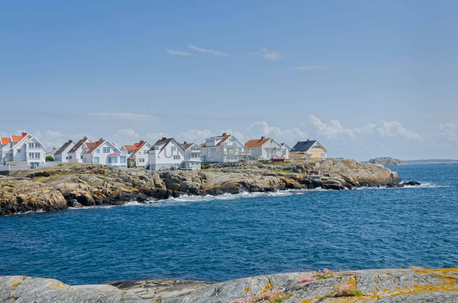 a little island on the swedish westcoast blue sky and it is blowing