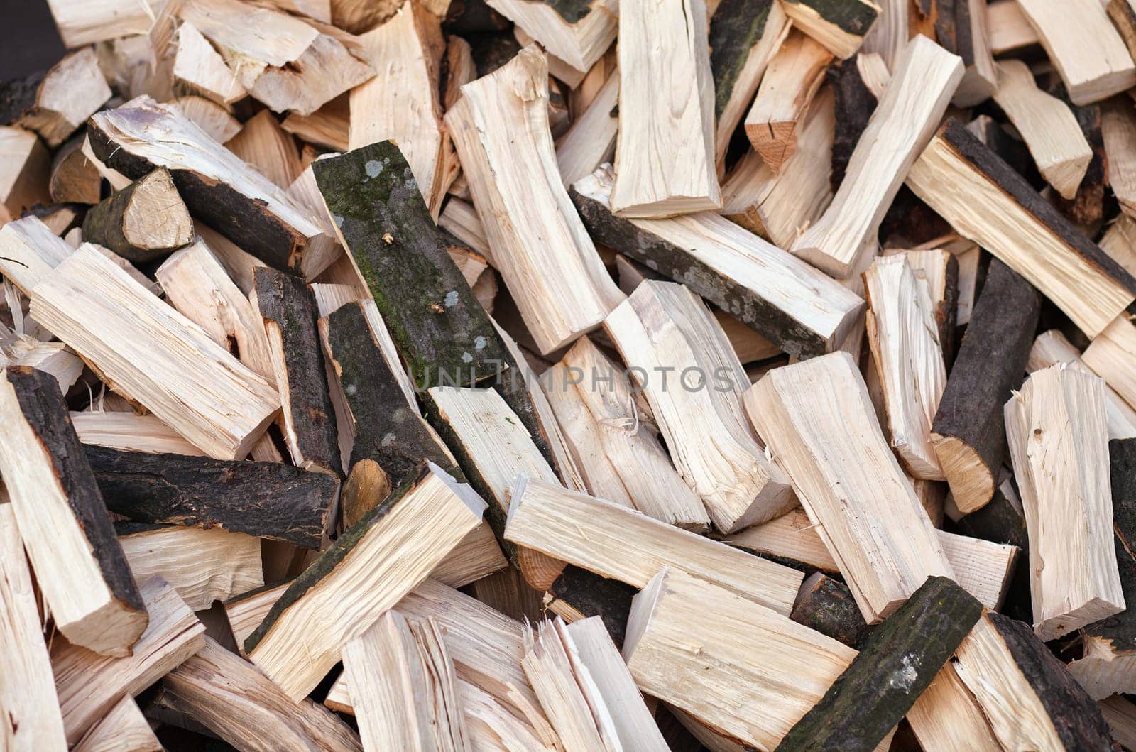 Firewood background - chopped firewood on a stack