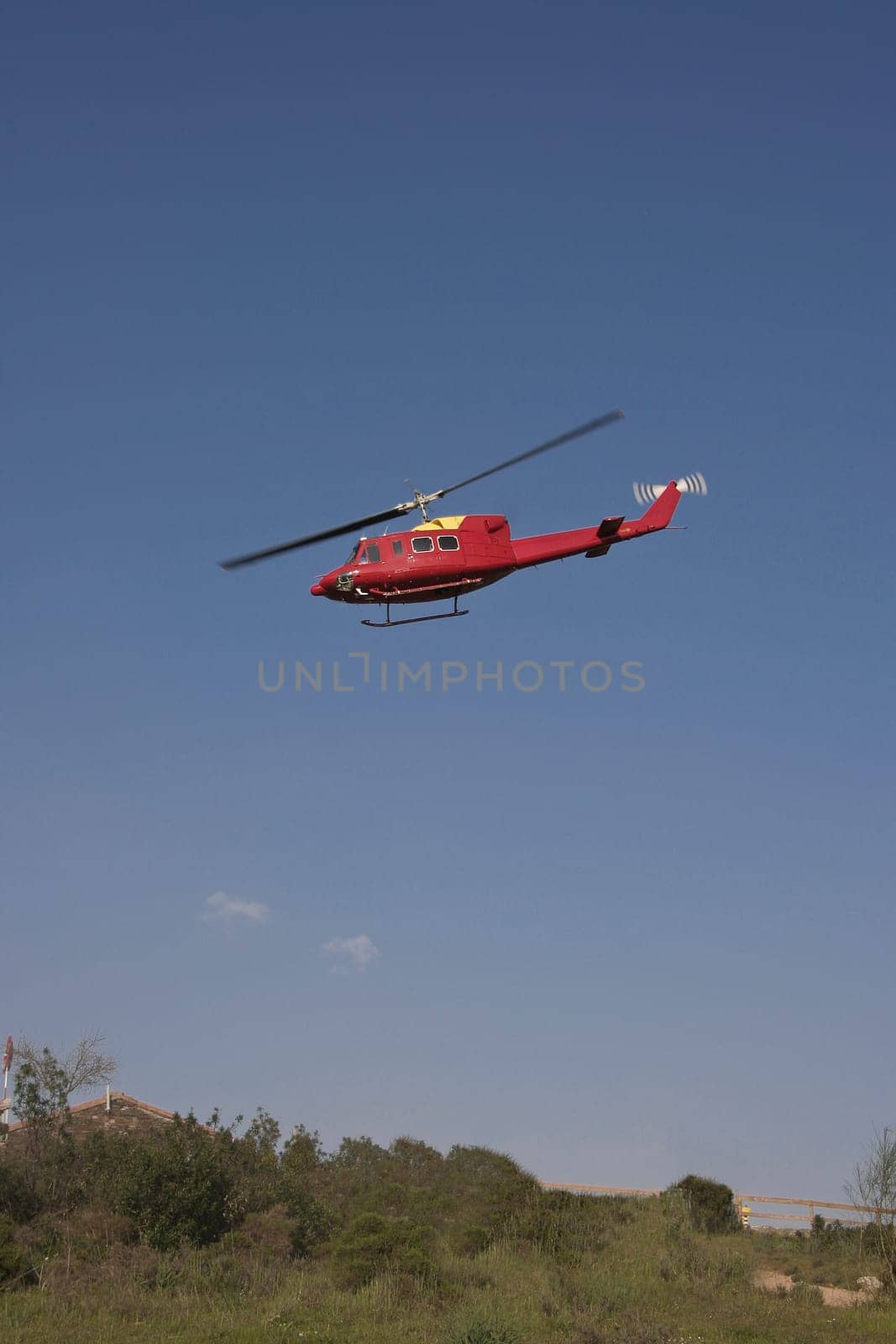 Yellow fire brigade helicopter on land, Spain