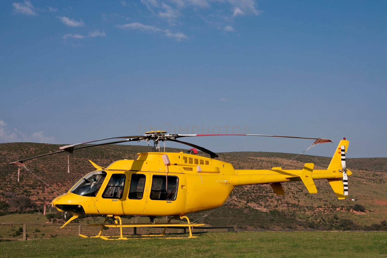 Yellow fire brigade helicopter on land, Spain