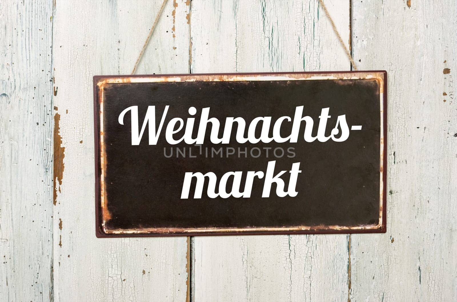 Old tin sign in front of white wooden wall - Christmas market