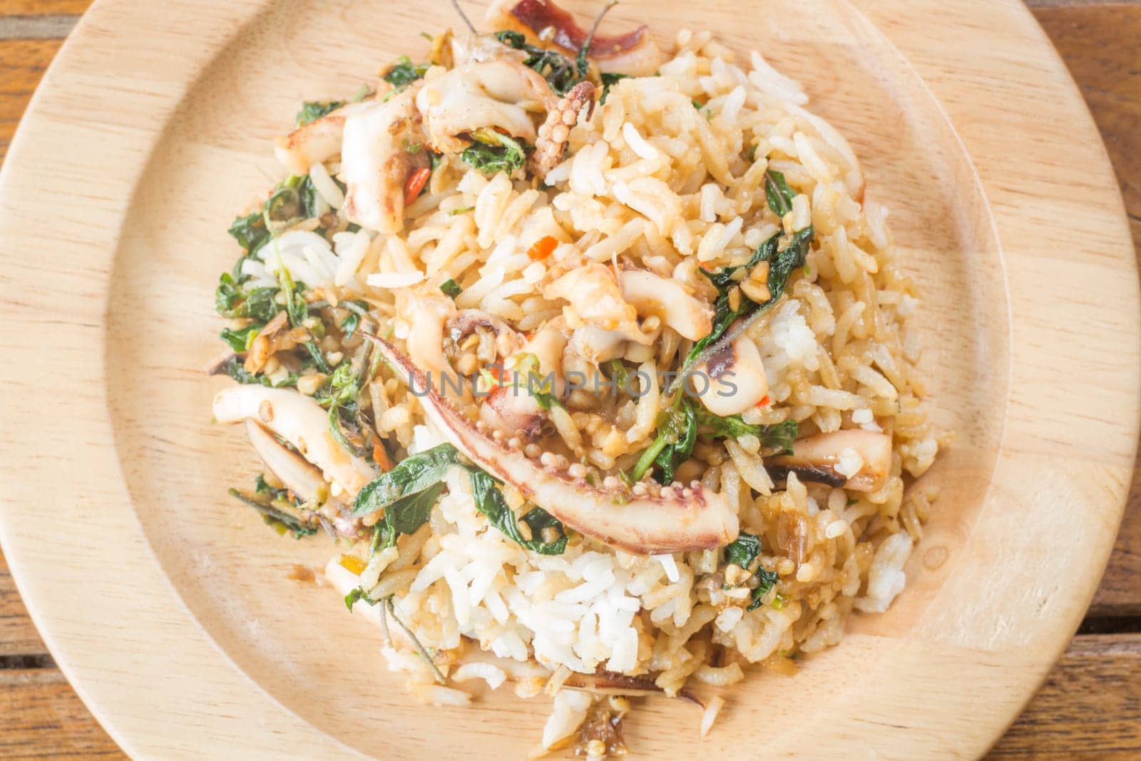 Rice topped with stir-fried squid basil (Thai food), stock photo