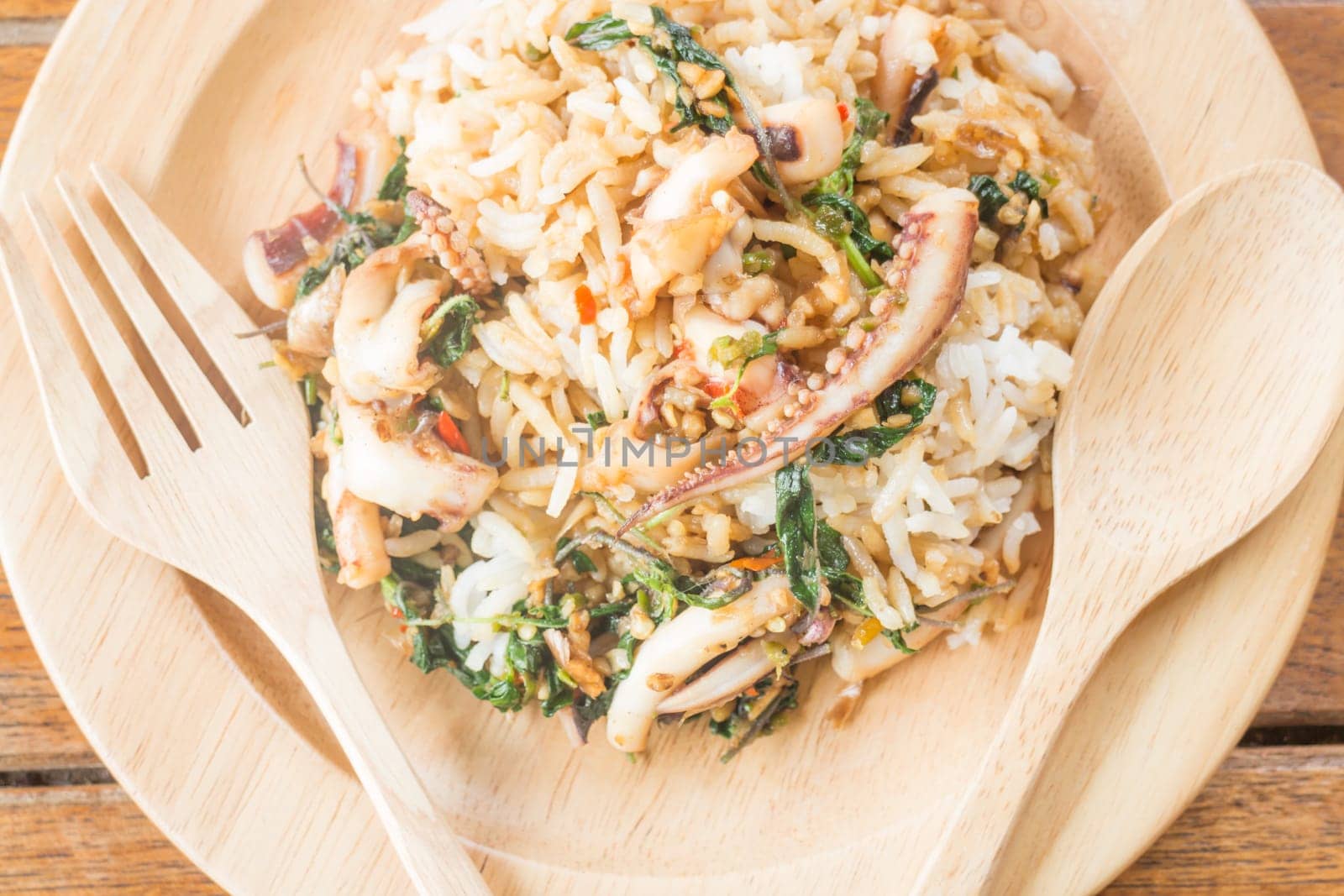 Rice topped with stir-fried squid basil (Thai food), stock photo