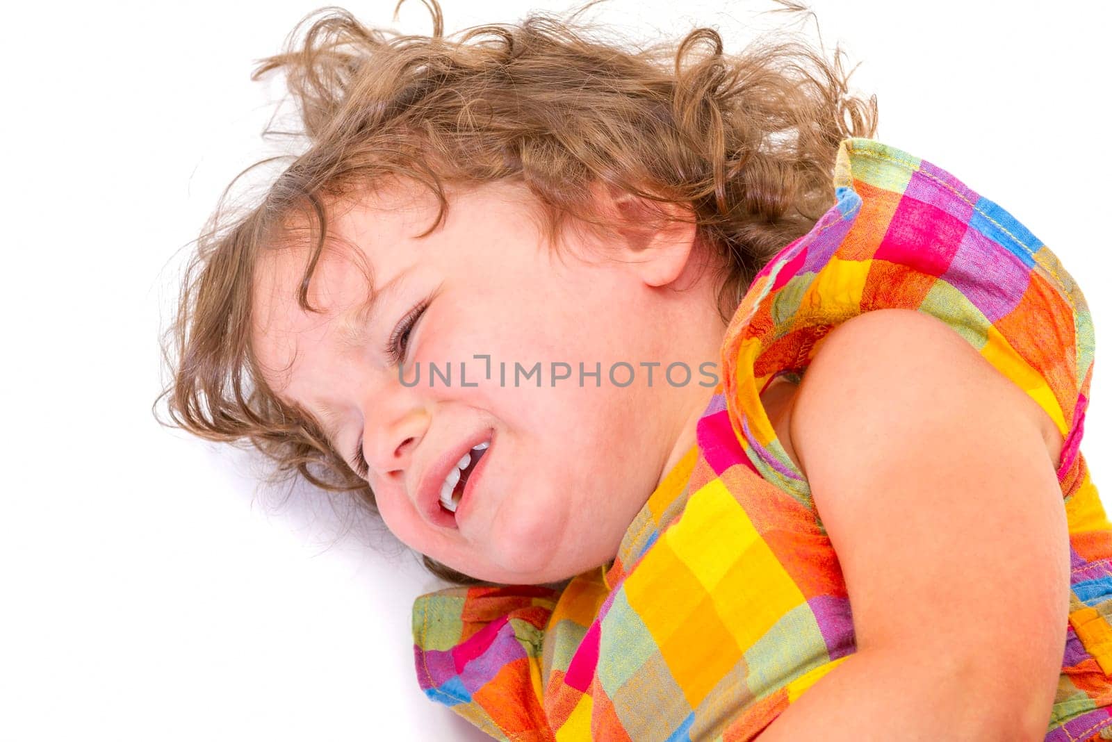 Sad little girl crying on white background.