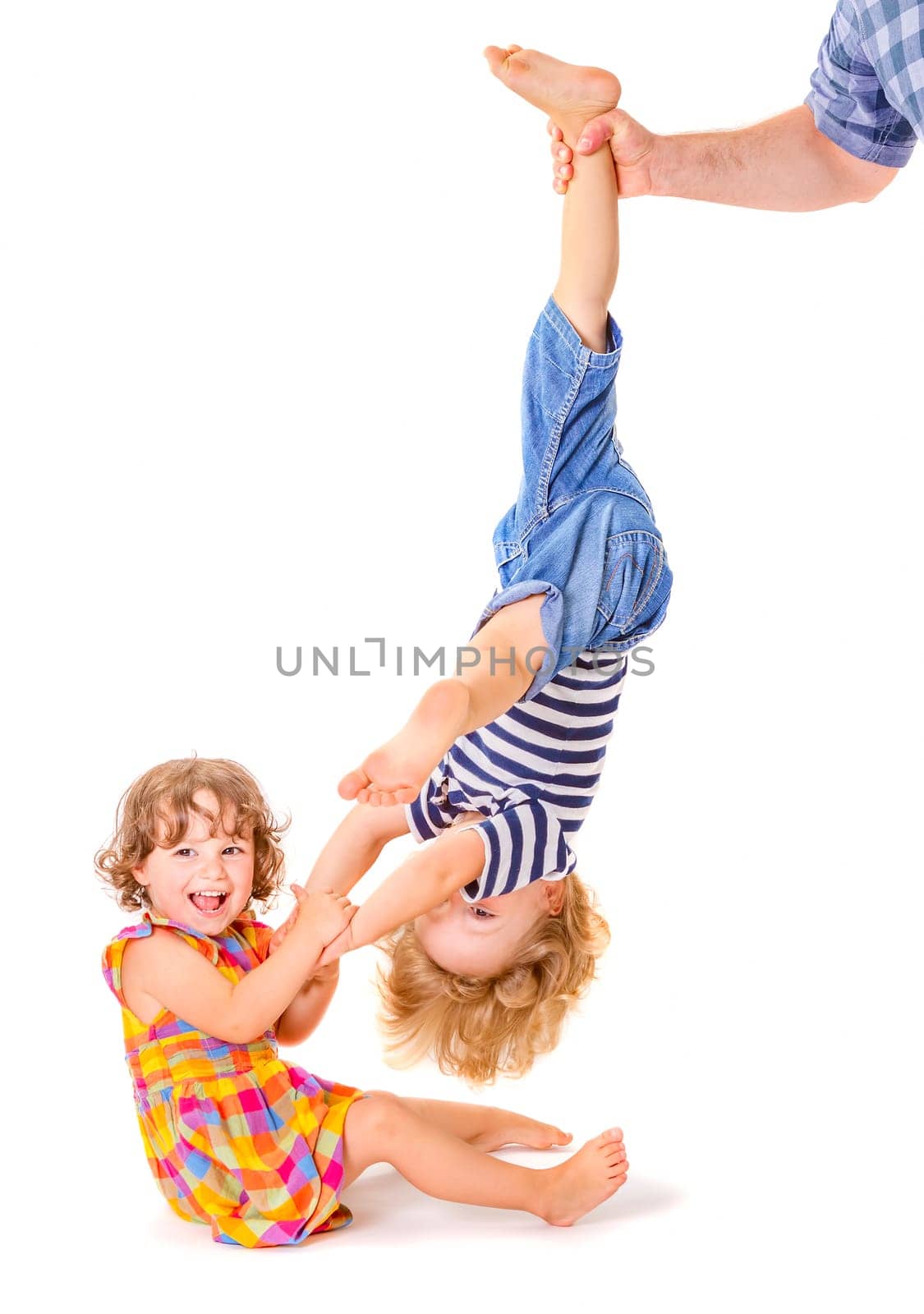 Happy little sister and brother playing together on white background