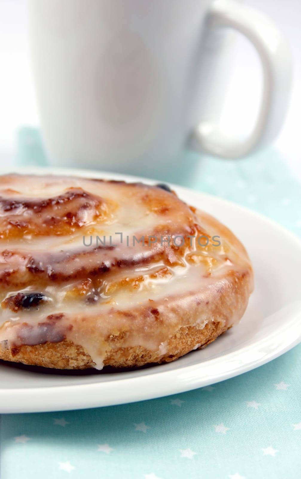 Raisin snail with white cup in the background