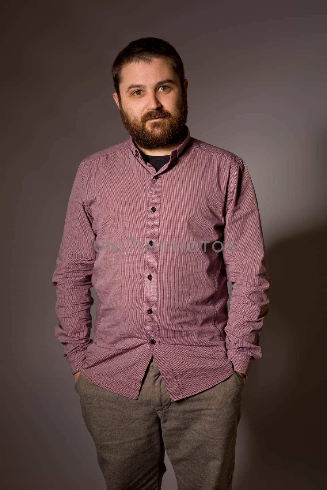 young casual man portrait in a dark background