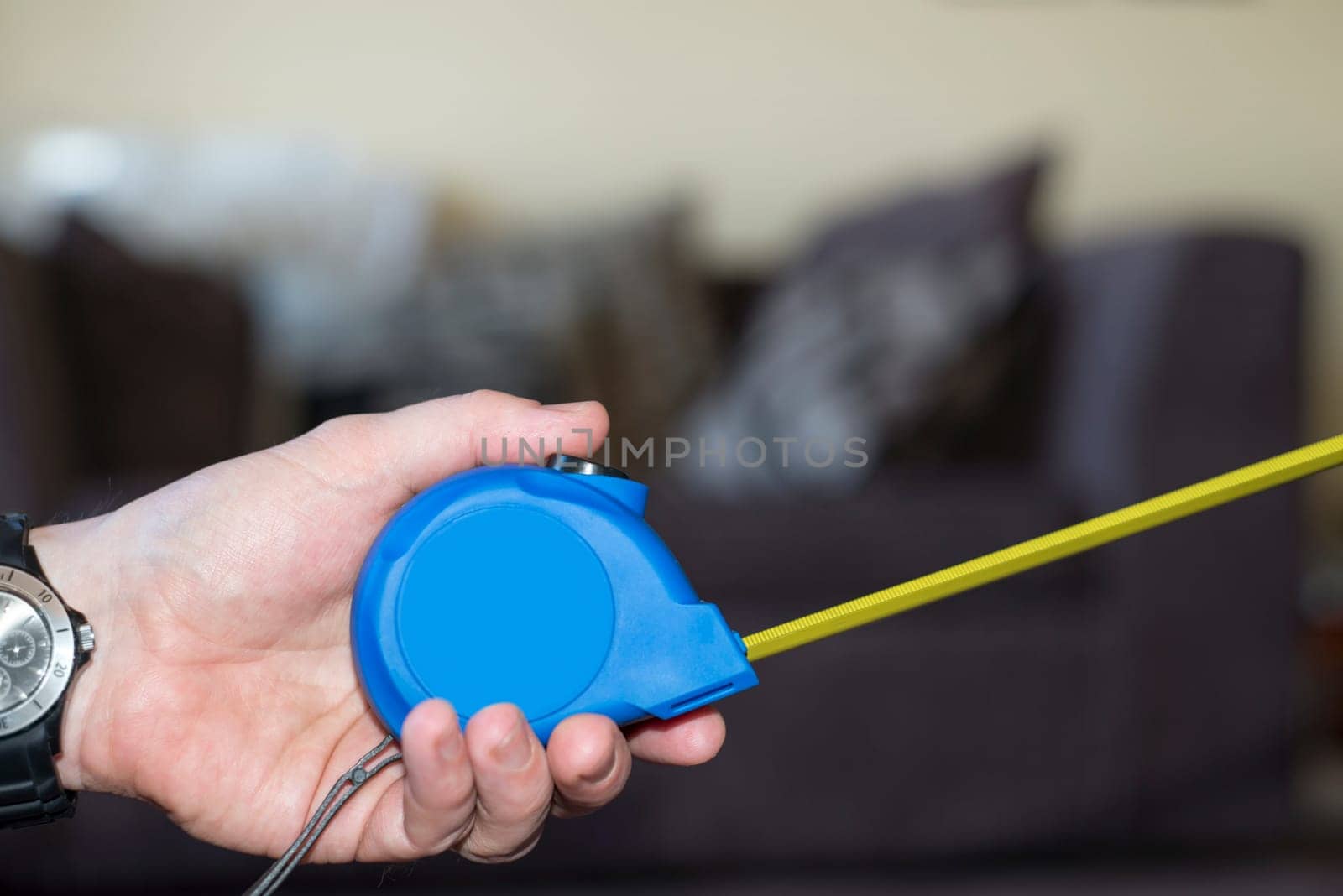 measuring tape in hand for do it yourself home improvements