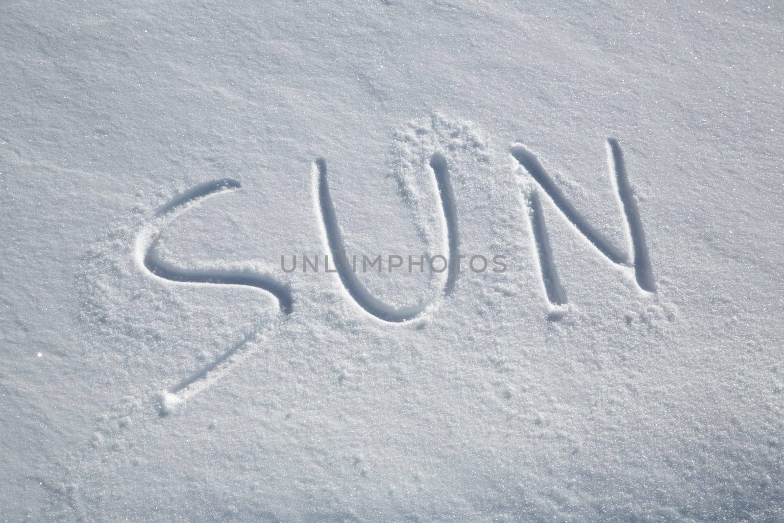 The word SUN written in the snow