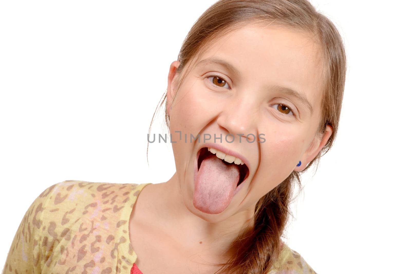little girl puts out her tongue isolated on the white background