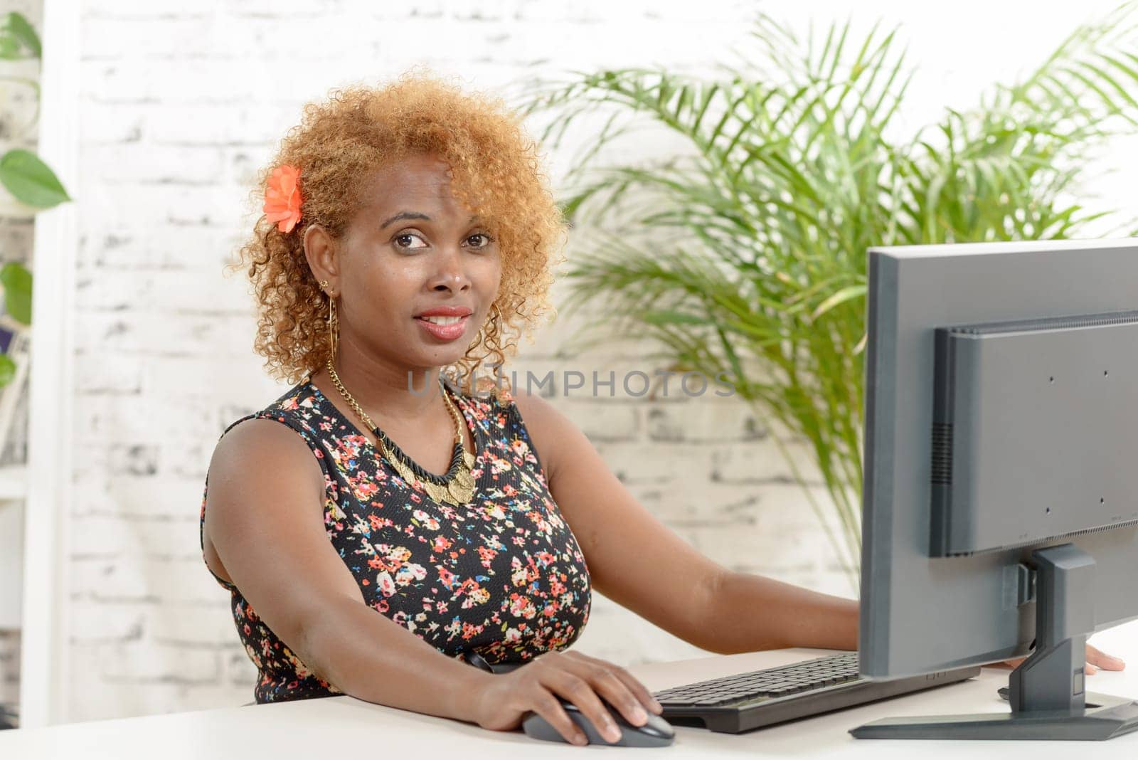 a young  smilling black secretary working with a computer