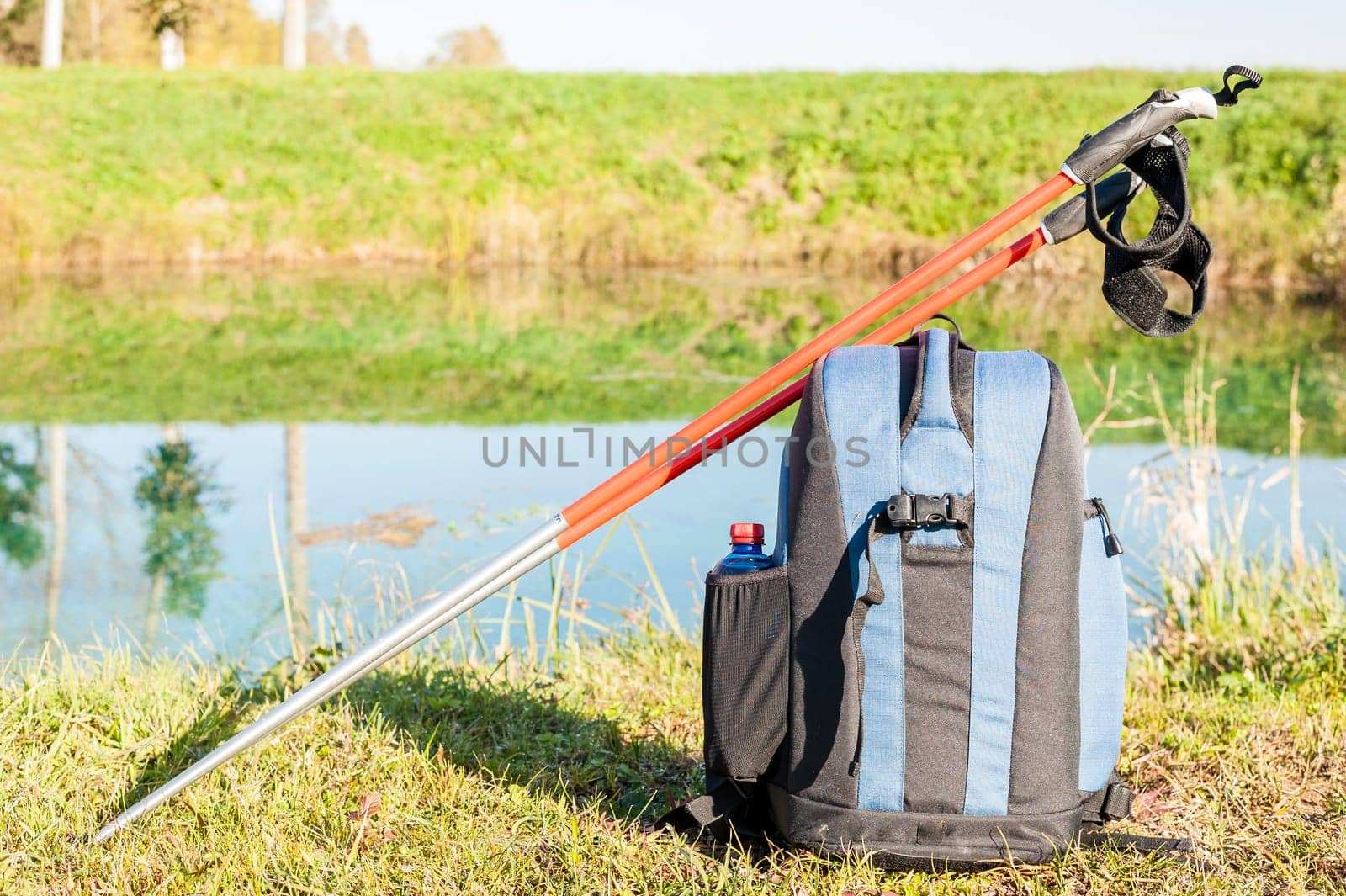Backpack and sticks to do nordic walking on country roads.