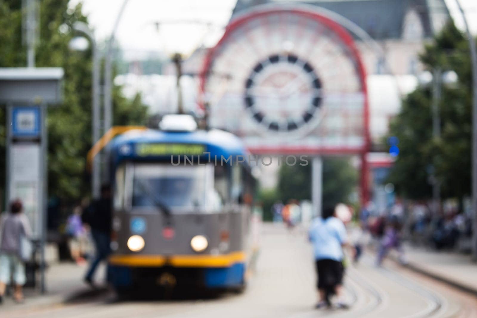 Out of focus shot of city street life, public transport and people using it. pedestrians walking about