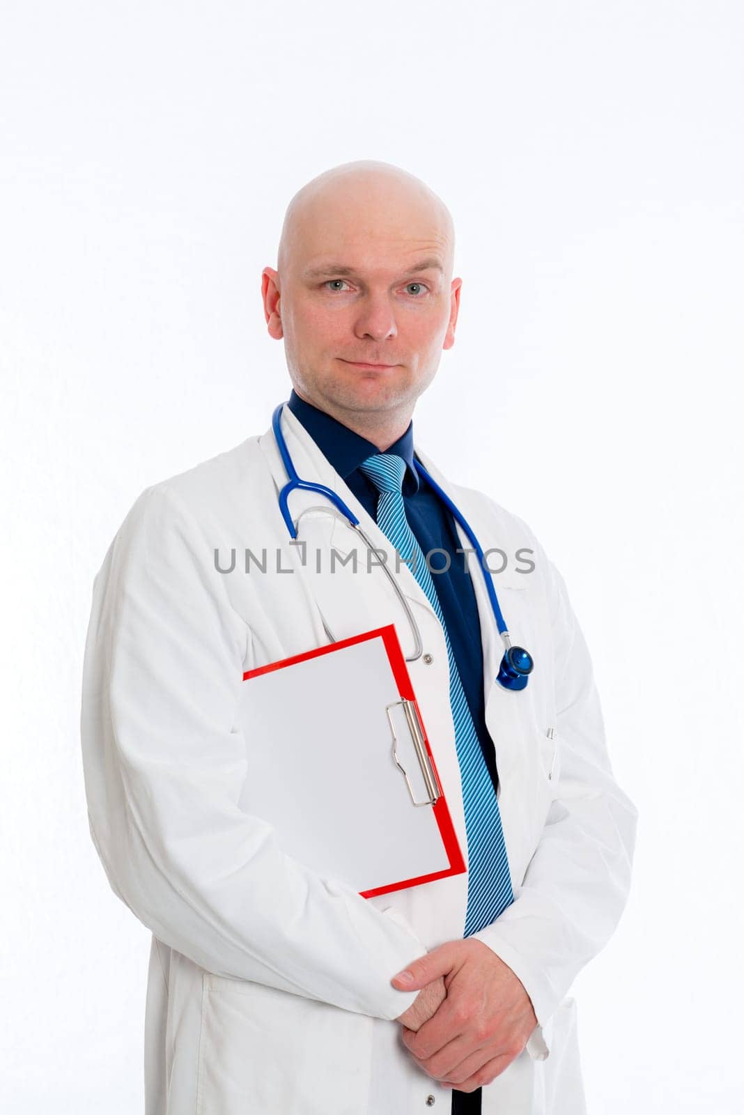 friendly young doctor with clipboard in front of white background