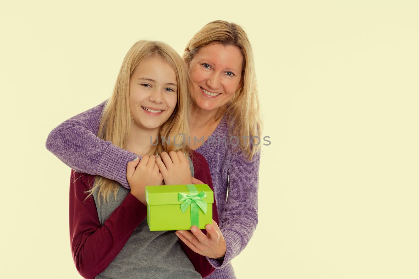 blond girl and woman with a green gift box