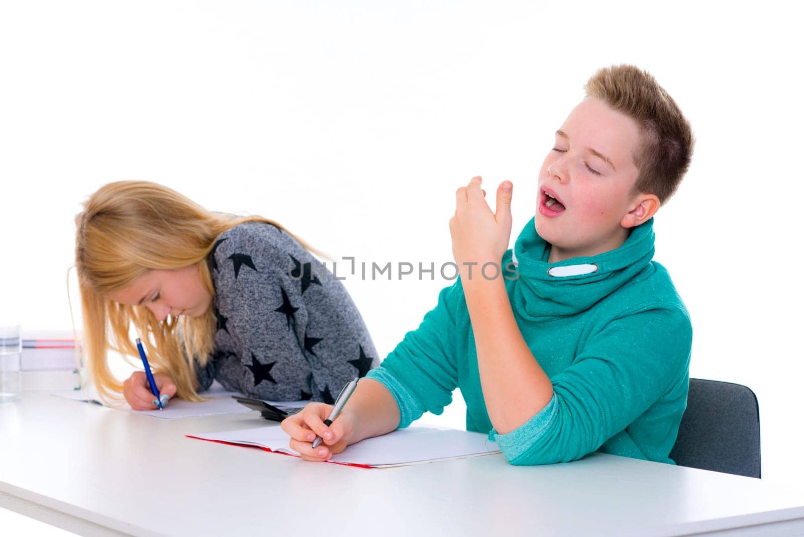 girl working and boy is tired in the classroom
