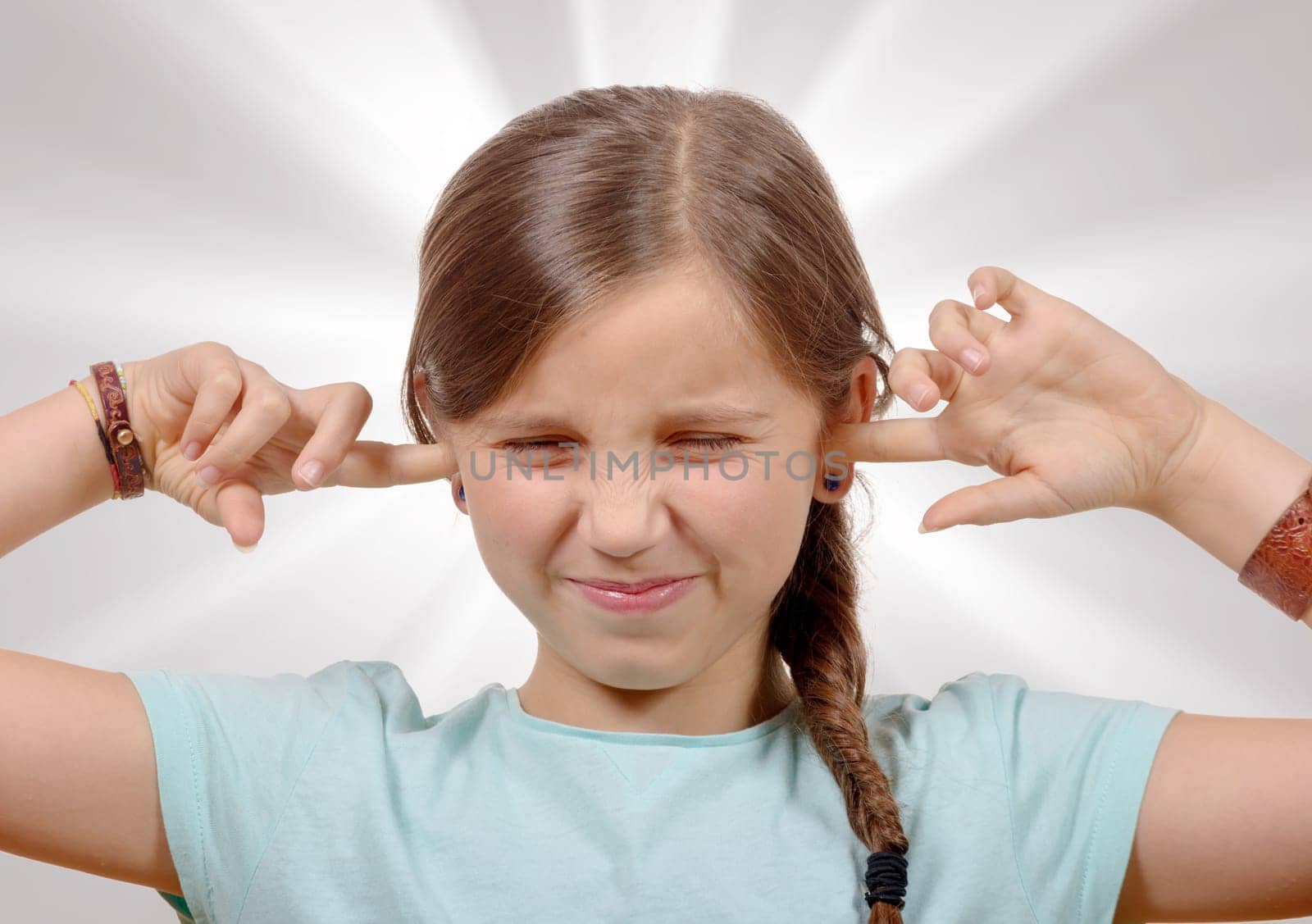 a little girl covering her ears,to say stop making loud noise giving me headache