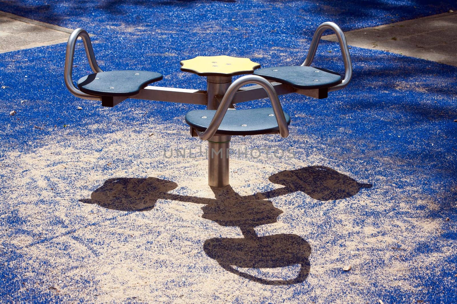 Carousel in a children playground with smiling shadow