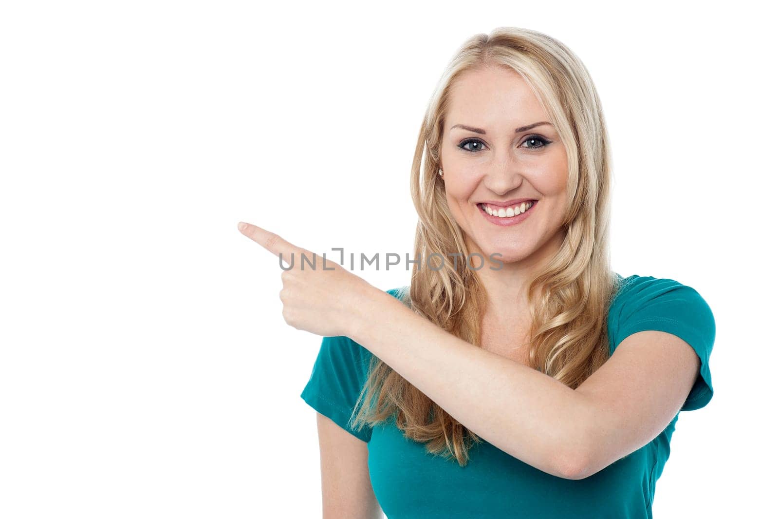 Young woman pointing at copy space area