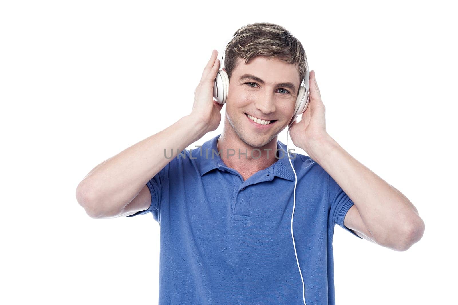 Smiling young guy enjoying music