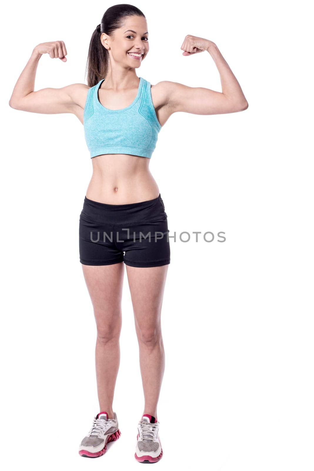 Young fit woman showing biceps