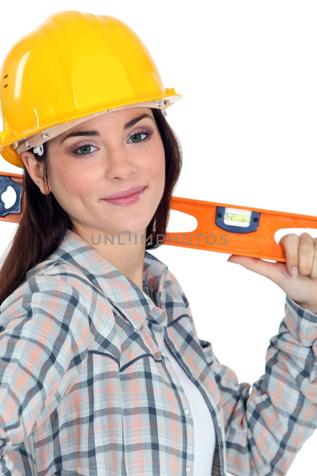 Female construction worker with a level.
