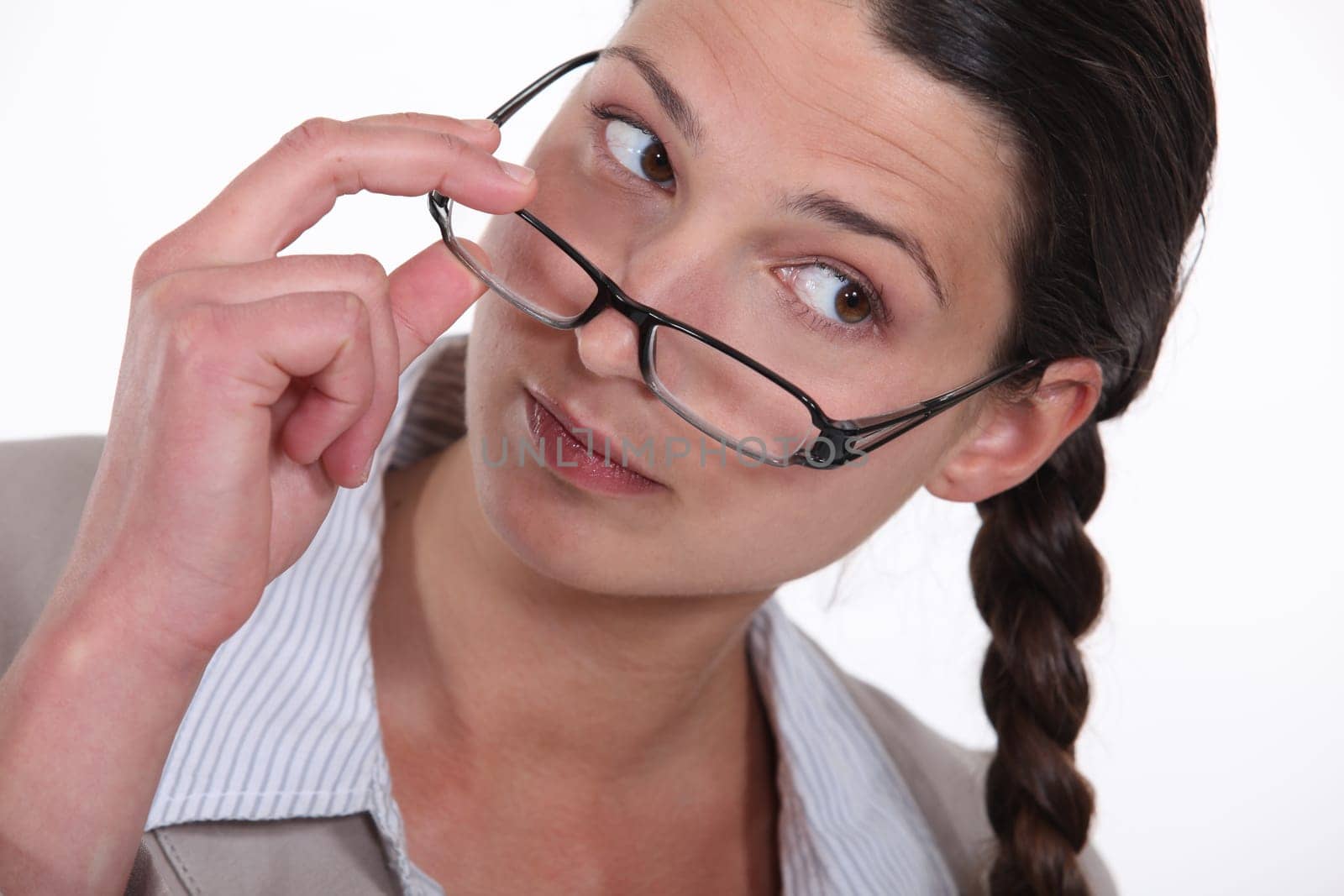 A businesswoman taking her glasses off.