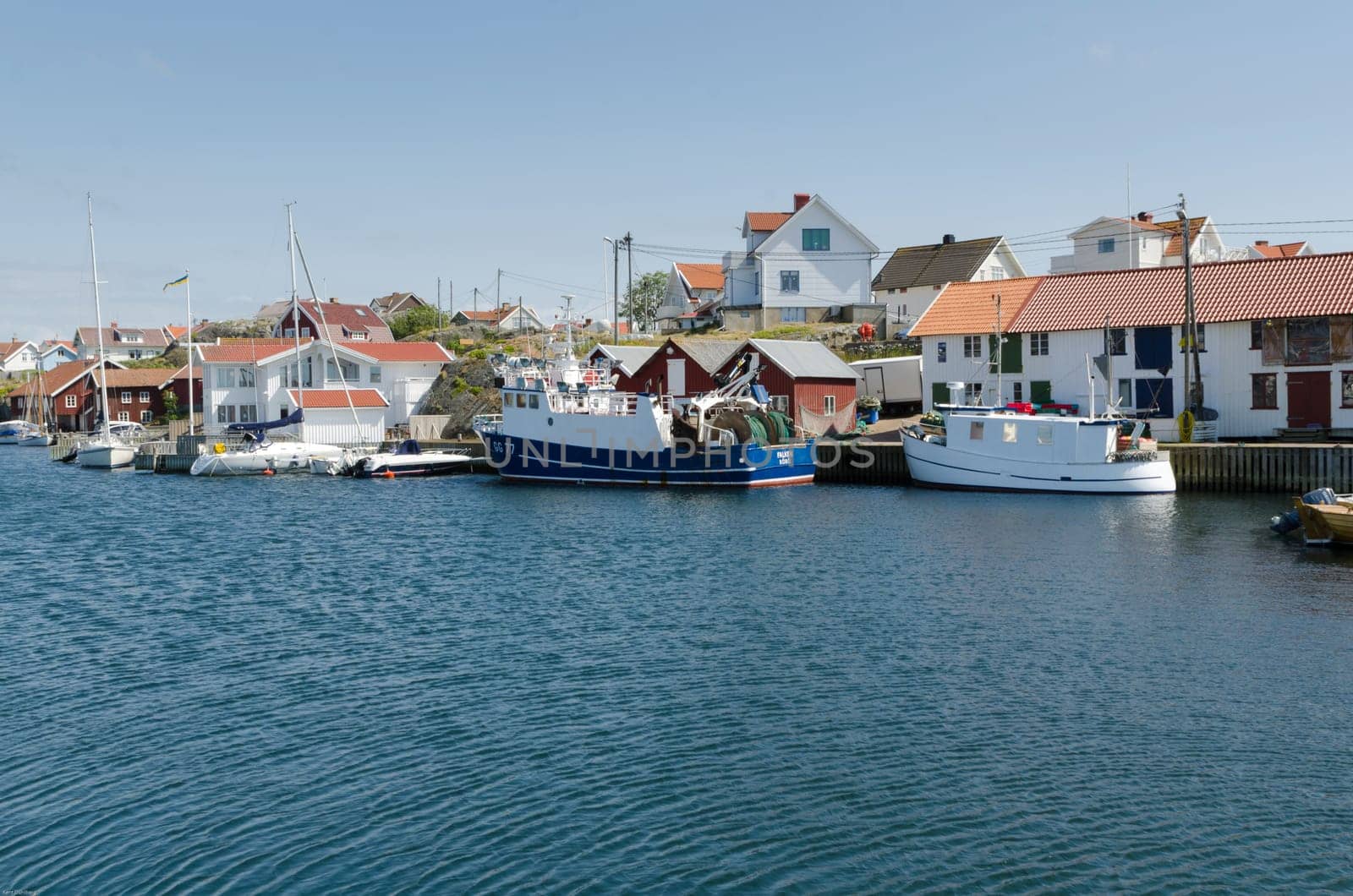 one harbour in sweden on the westcoast a fishingboat and many other boat