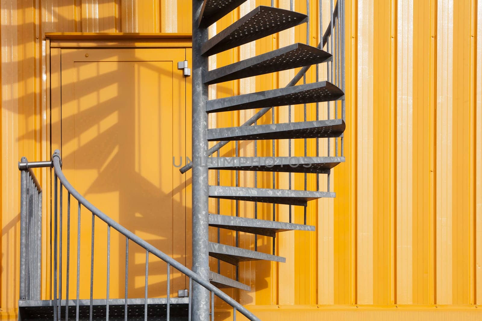 Yellow metal building with spiral metal staircase