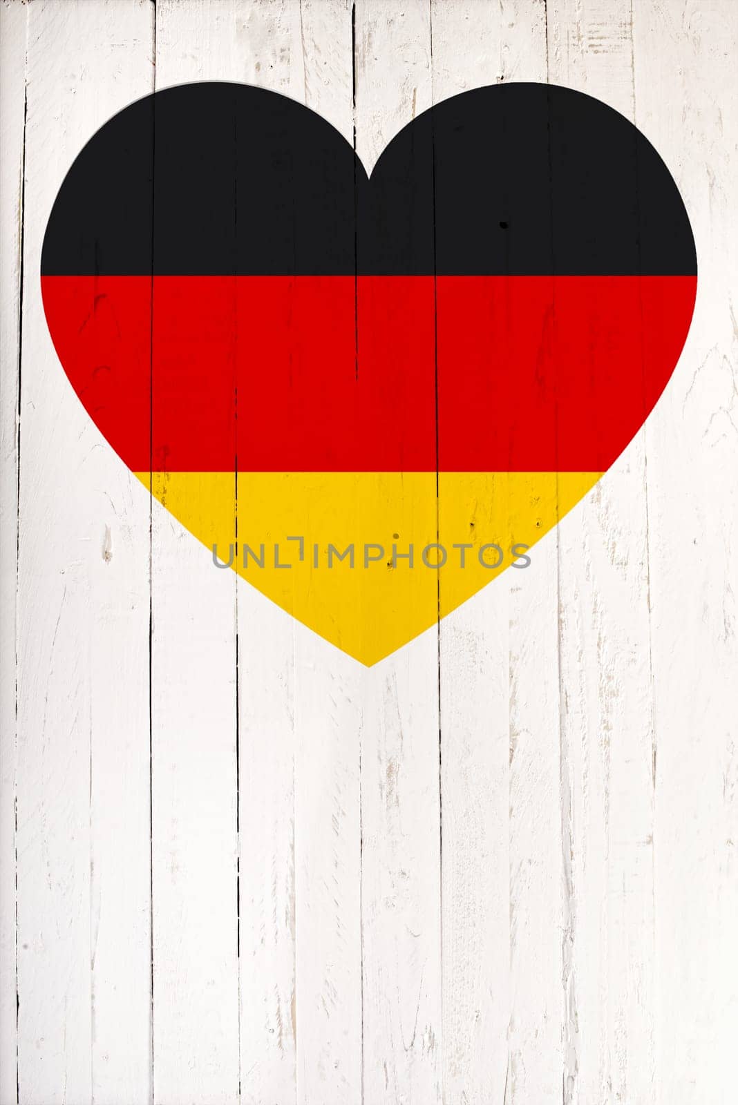 German flag in heart shape on a  old white wooden board
