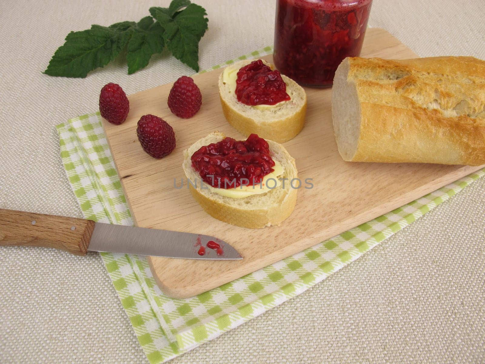 Breakfast with raspberry jam and baguette