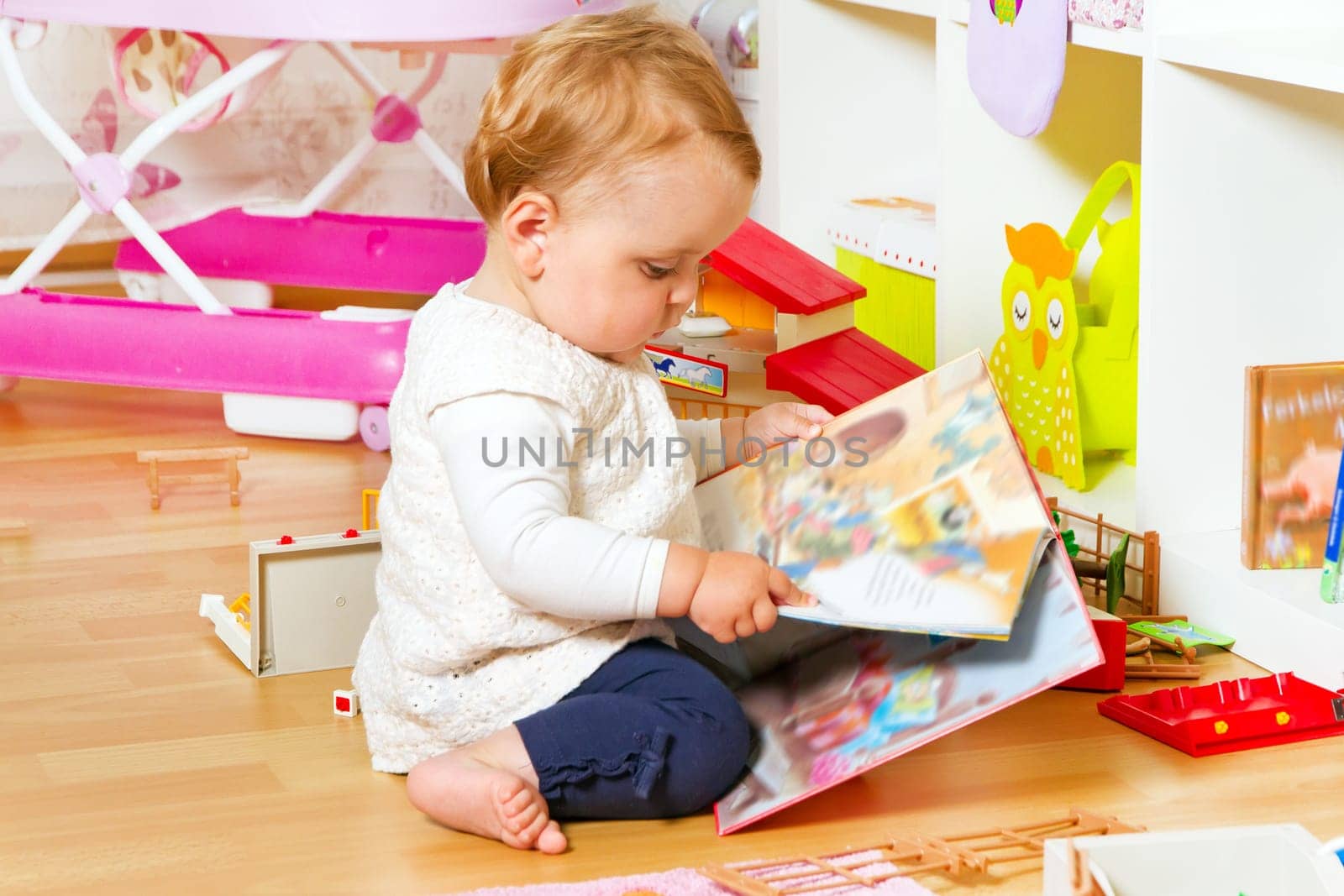 Little baby with picture book