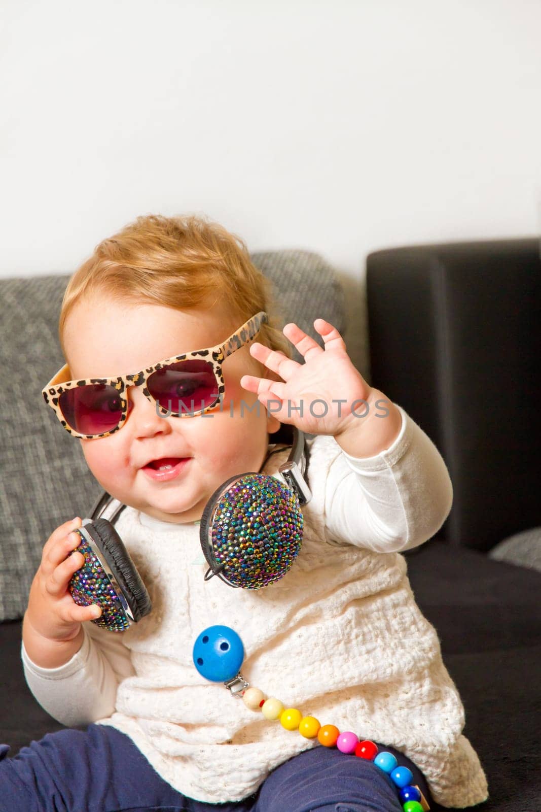 Funny baby with headphones and sunglasses