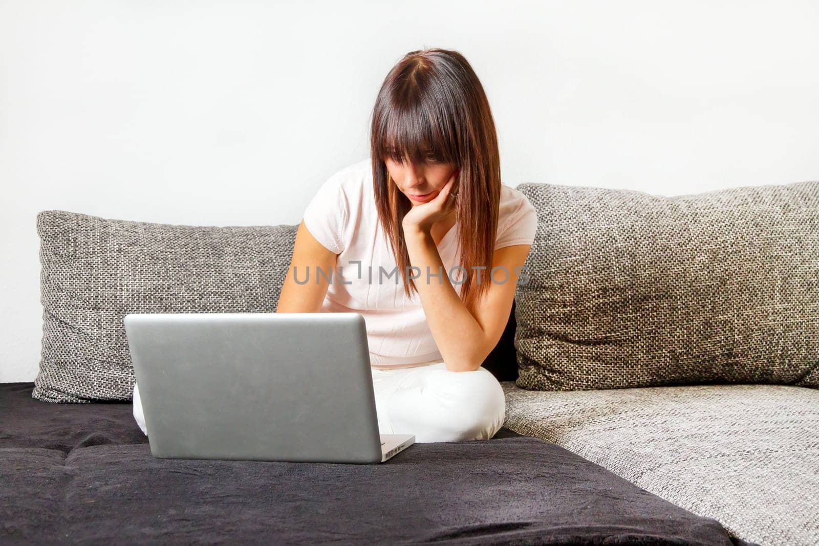 Thoughtful young woman on computer