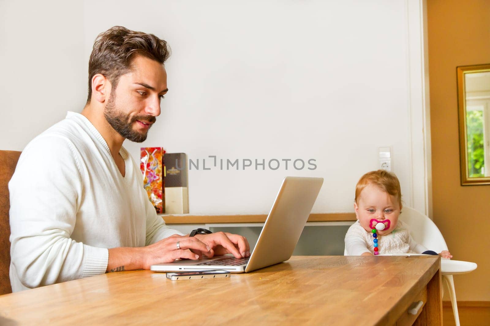 Father works at home on the computer